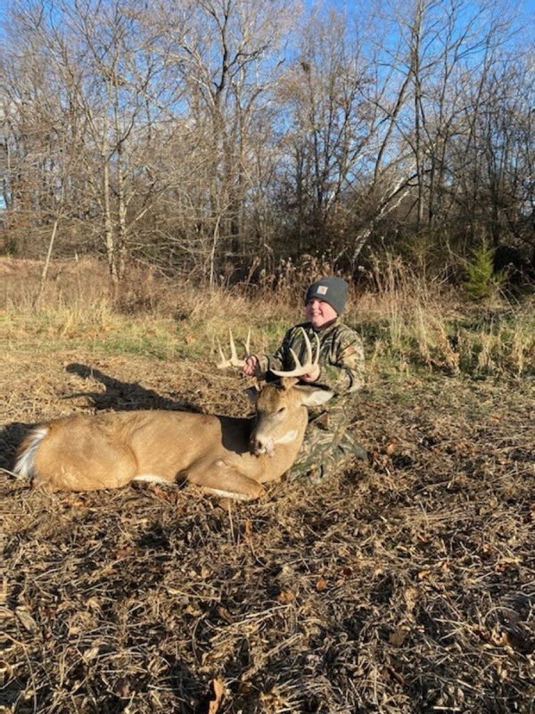 Young hunter with a Missouri whitetail buck on a clear morning